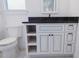 Bathroom features a marble counter on a vanity and a toilet, with a window above at 0 Orangewood Ave, St Cloud, FL 34772