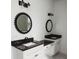 Elegant bathroom with dual vanities, stylish mirrors, and modern lighting fixtures at 0 Orangewood Ave, St Cloud, FL 34772
