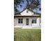 Home's charming front porch with natural wood columns and a modern front door at 0 Orangewood Ave, St Cloud, FL 34772