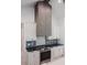Modern kitchen featuring stainless steel appliances, custom cabinetry, and tiled backsplash at 0 Orangewood Ave, St Cloud, FL 34772