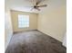 Bright bedroom features wall-to-wall carpeting, a ceiling fan, and a large window at 1091 S Hiawassee Rd # 216, Orlando, FL 32835
