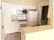 Bright kitchen features white cabinets, matching appliances, and a washer/dryer closet at 1091 S Hiawassee Rd # 216, Orlando, FL 32835