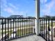 Balcony with black metal railing, offering a view of the surrounding neighborhood at 113 Kenny Blvd, Haines City, FL 33844