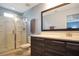 Bright bathroom featuring a tiled shower, modern vanity, and stylish mirror at 113 Kenny Blvd, Haines City, FL 33844