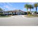 Exterior shot of the clubhouse with neat landscaping and paved walkway at 113 Kenny Blvd, Haines City, FL 33844