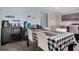 Dining area with table set for four, bar, and view into the adjacent kitchen at 113 Kenny Blvd, Haines City, FL 33844