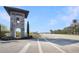 Community entrance featuring a stone tower under a clear sky at 113 Kenny Blvd, Haines City, FL 33844