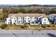 Attractive townhouse with multiple balconies, modern white facade, and manicured front lawns at 113 Kenny Blvd, Haines City, FL 33844