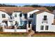 Townhouse featuring a private patio with outdoor furniture and a well-manicured front yard at 113 Kenny Blvd, Haines City, FL 33844