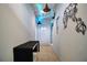 Hallway featuring artistic wall maps and unique decorative ceiling lighting at 113 Kenny Blvd, Haines City, FL 33844