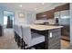 Open kitchen with a breakfast bar island, stainless steel appliances, and modern cabinetry at 113 Kenny Blvd, Haines City, FL 33844