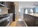 Modern kitchen with stainless steel appliances and dark wood cabinetry at 113 Kenny Blvd, Haines City, FL 33844