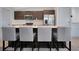 Modern kitchen with stainless steel appliances, island with seating, and sleek cabinetry at 113 Kenny Blvd, Haines City, FL 33844