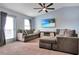 Open-plan living room offers a comfortable seating area with television and natural light at 113 Kenny Blvd, Haines City, FL 33844