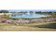 View of a community pond with fountain and grassy shoreline at 113 Kenny Blvd, Haines City, FL 33844