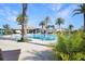 Community pool area with palm trees and lounge chairs, perfect for relaxing and enjoying the Florida sunshine at 113 Kenny Blvd, Haines City, FL 33844