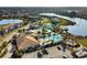 Community aerial view showcasing a large pool, waterslide, lakeside gazebo, and lounge seating at 113 Kenny Blvd, Haines City, FL 33844