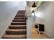 Staircase featuring carpet steps and whimsical ceiling decor at 113 Kenny Blvd, Haines City, FL 33844