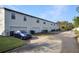 Street view of a townhouse complex with private garages at 113 Kenny Blvd, Haines City, FL 33844