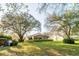 Spacious backyard featuring mature trees and green grass at 1145 Sugar Belt Dr, St Cloud, FL 34771