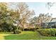 Lush green backyard with mature trees, and screened enclosure at 1145 Sugar Belt Dr, St Cloud, FL 34771