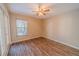 Spacious bedroom with wood floors, neutral paint, french doors, and a large window at 1145 Sugar Belt Dr, St Cloud, FL 34771