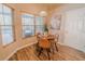 Charming breakfast nook with a round table, three chairs, and natural light streaming in through windows at 1145 Sugar Belt Dr, St Cloud, FL 34771