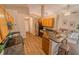 Cozy kitchen with wood cabinets, modern appliances, breakfast bar, and open access to the living area at 1145 Sugar Belt Dr, St Cloud, FL 34771