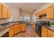 Well-lit kitchen with wood cabinets, laminate countertops, and stainless steel appliances at 1145 Sugar Belt Dr, St Cloud, FL 34771