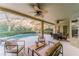 Covered patio area overlooking a screened-in pool, with comfortable seating, ceiling fans, and an outdoor lounge at 1145 Sugar Belt Dr, St Cloud, FL 34771