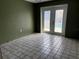 View of a tiled room with a set of glass doors leading out to a pool at 116 Hampden Rd, Winter Haven, FL 33884