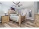 Relaxing bedroom with a decorative ceiling fan, beautiful furnishings, and ample natural light from the windows at 13008 Baltimore Woods Ln, Orlando, FL 32824