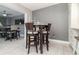 Cozy dining area featuring a stylish table with high chairs and view into adjoining table with ceiling fan at 13008 Baltimore Woods Ln, Orlando, FL 32824