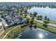 Scenic aerial view of the home by a beautiful pond and walking path at 13432 Beebe Aly, Orlando, FL 32827