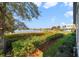 Scenic backyard view overlooking a tranquil lake, lush greenery, and a neighborhood at 13432 Beebe Aly, Orlando, FL 32827