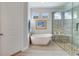 This updated bathroom features a soaking tub, glass shower, and a window for natural light at 13432 Beebe Aly, Orlando, FL 32827