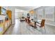Dining area features a modern glass table, leather chairs, and stylish light fixture at 13432 Beebe Aly, Orlando, FL 32827
