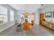Well-lit dining room featuring a glass table set, adjacent to kitchen and living spaces at 13432 Beebe Aly, Orlando, FL 32827