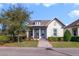 Charming single-story home with a well-manicured lawn and a welcoming front porch under a partly cloudy sky at 13432 Beebe Aly, Orlando, FL 32827