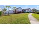 Spacious front yard with lush green lawn and walkway leading to a charming single-Gathering home at 13432 Beebe Aly, Orlando, FL 32827