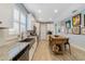 Modern kitchen with white cabinets, stainless steel appliances, granite countertops, and a charming wood island at 13432 Beebe Aly, Orlando, FL 32827
