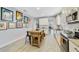 This light and bright kitchen features stainless steel appliances, white cabinets and an island with a wood countertop at 13432 Beebe Aly, Orlando, FL 32827