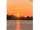 Beautiful lake view with shimmering water reflecting a golden sunset and tranquil setting at 13432 Beebe Aly, Orlando, FL 32827