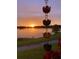 Mesmerizing sunset over the lake, framed by ornamental flower garden and landscape, reflecting on water at 13432 Beebe Aly, Orlando, FL 32827