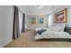 Elegant main bedroom featuring neutral carpet, tray ceilings, modern art, and large windows with sheer curtains at 13432 Beebe Aly, Orlando, FL 32827