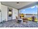 Charming covered patio with brick pavers offers a tranquil outdoor living space and serene water views at 13432 Beebe Aly, Orlando, FL 32827