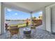 Inviting covered patio with brick pavers and scenic lake views offers an outdoor seating area at 13432 Beebe Aly, Orlando, FL 32827
