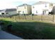 Spacious backyard featuring a dark metal fence, offering privacy and security at 1360 Berry Ln, Davenport, FL 33837