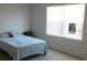 Cozy bedroom featuring a bed, a window, and carpeted floors at 1360 Berry Ln, Davenport, FL 33837