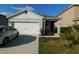 Charming single-story home with well-maintained landscaping and a two-car garage at 1360 Berry Ln, Davenport, FL 33837